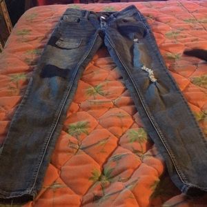 Ripped jeans that have patches on them.